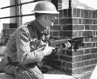 British soldier wielding a Thompon SMG fitted with a Cutts Compensator