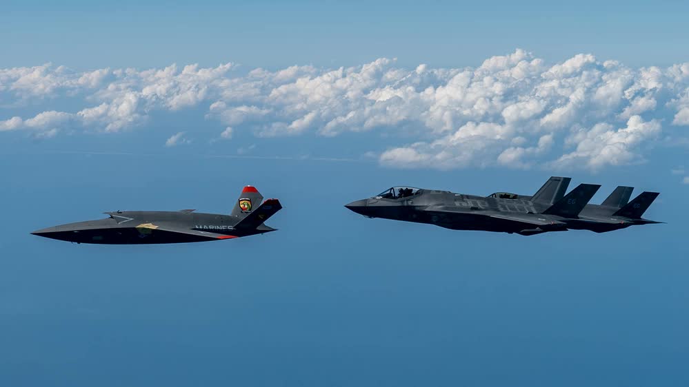 XQ-58A Valkyrie flies alongside F-35