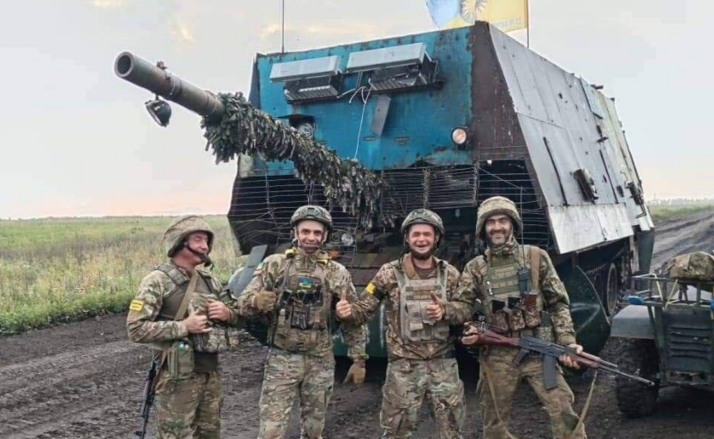 Ukrainian soldiers with captured Russian tank