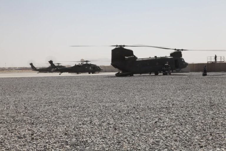 Chinook and Black Hawk helicopters refuel