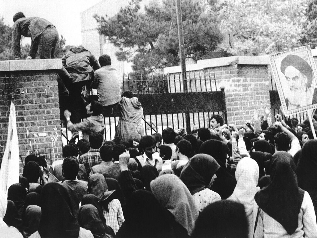 Iranian students climb the US Embassy in Tehran during the hostage crisis