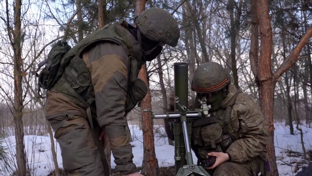 Russian soldiers examining mortar