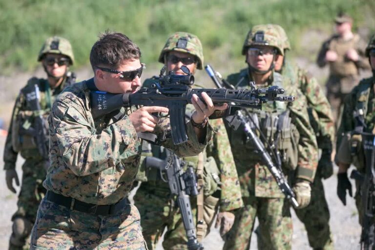 Marine demonstrates sight alignment to Japanese soldiers