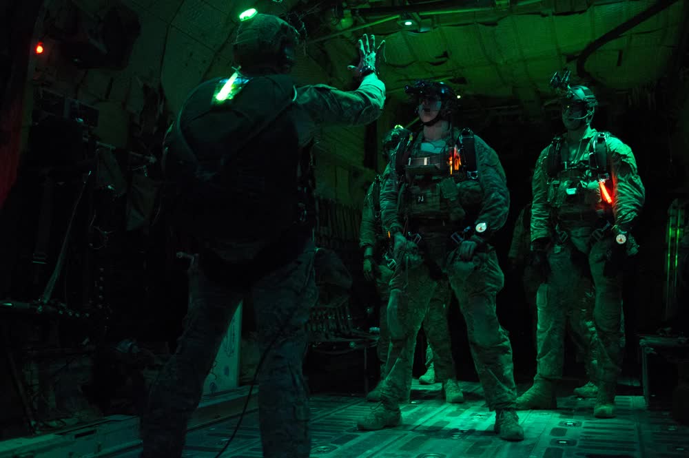 Pararescuemen prepare to jump from C-130