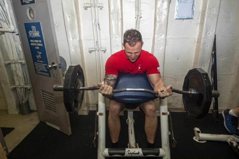 Sailor works out in ship's gym