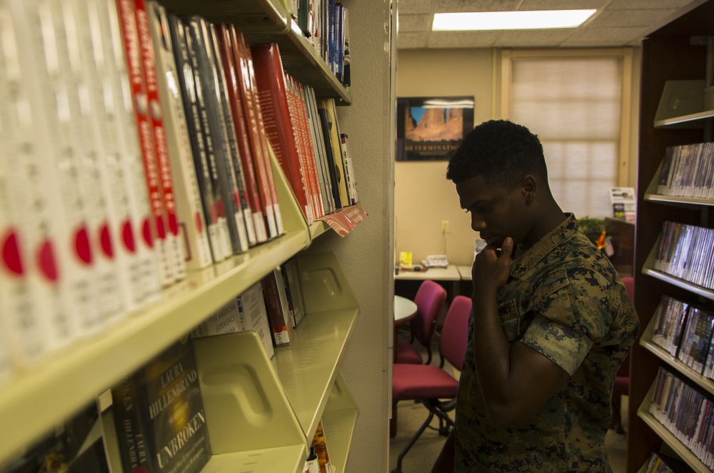 Marine picks up books from station library